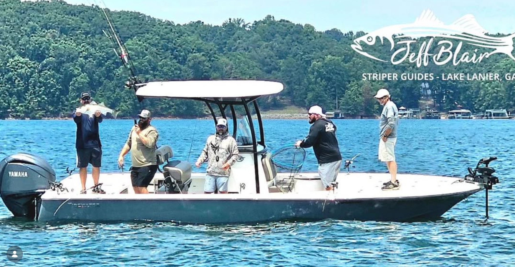 Jeff Blair Striper Guides charter boat on Lake Lanier with anglers and a striped bass catch